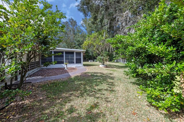 view of yard with a sunroom