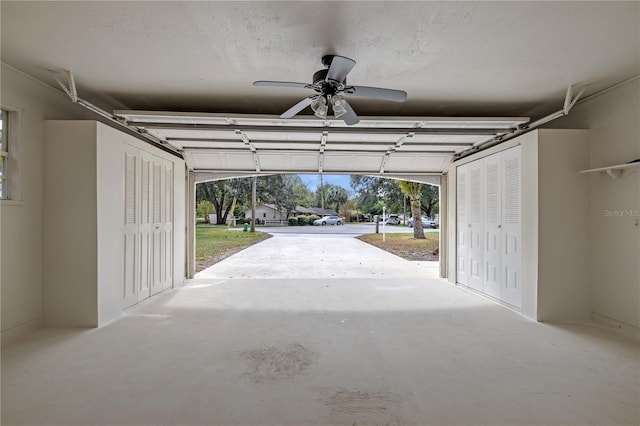 garage with ceiling fan and a carport