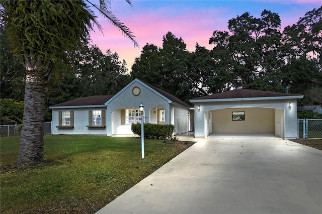 ranch-style home with a lawn and a carport