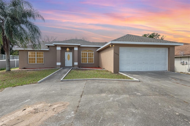 view of front of property featuring a garage and a yard