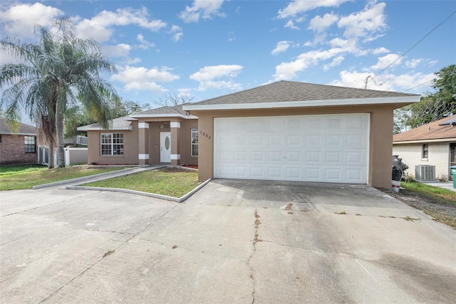 view of front of home with a garage and cooling unit