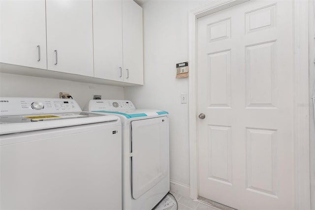 washroom featuring light tile patterned floors, cabinets, and independent washer and dryer