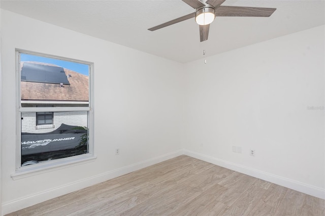 unfurnished room with light wood-type flooring and ceiling fan