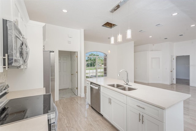 kitchen featuring white cabinetry, sink, hanging light fixtures, a center island with sink, and appliances with stainless steel finishes