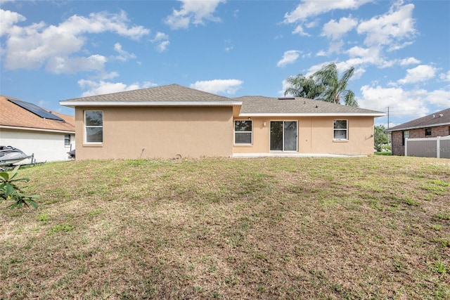 rear view of house with a lawn