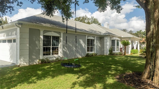 view of side of home featuring a yard and a garage