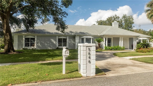 ranch-style home with a front yard