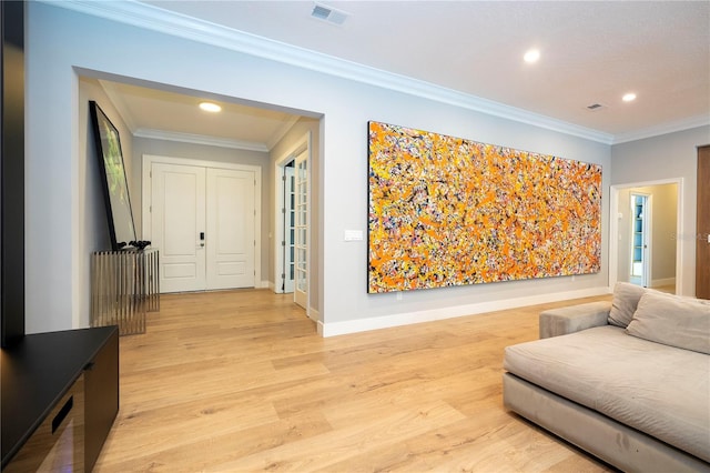 hallway featuring light hardwood / wood-style floors and crown molding