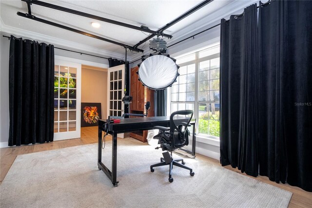 home office featuring light wood-type flooring and ornamental molding