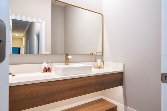 bathroom with hardwood / wood-style floors, vanity, and ornamental molding