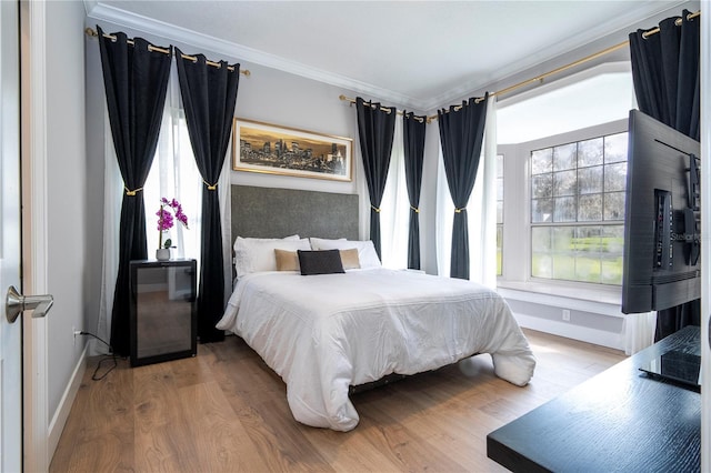 bedroom featuring hardwood / wood-style flooring and crown molding