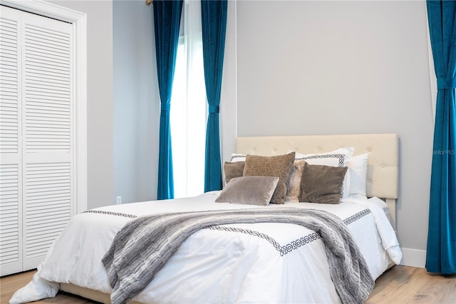 bedroom featuring light wood-type flooring and a closet