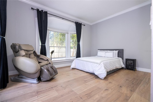 bedroom featuring light wood-type flooring and crown molding