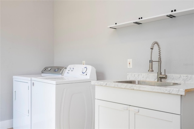 clothes washing area featuring sink and washing machine and clothes dryer