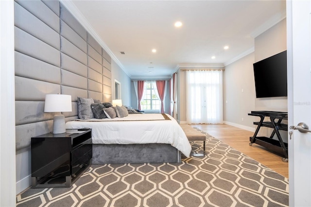 bedroom with ornamental molding and light hardwood / wood-style flooring