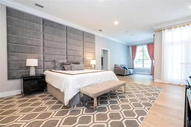 bedroom with hardwood / wood-style floors, crown molding, and tile walls