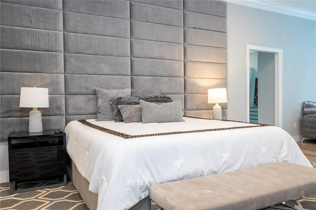 bedroom with wood-type flooring and crown molding