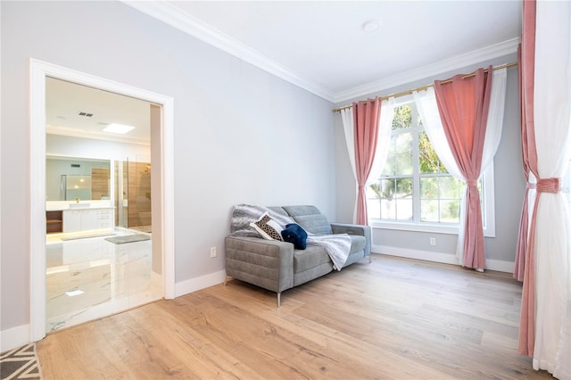 living area featuring ornamental molding and light hardwood / wood-style flooring