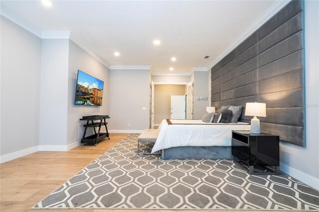 bedroom featuring hardwood / wood-style flooring and crown molding