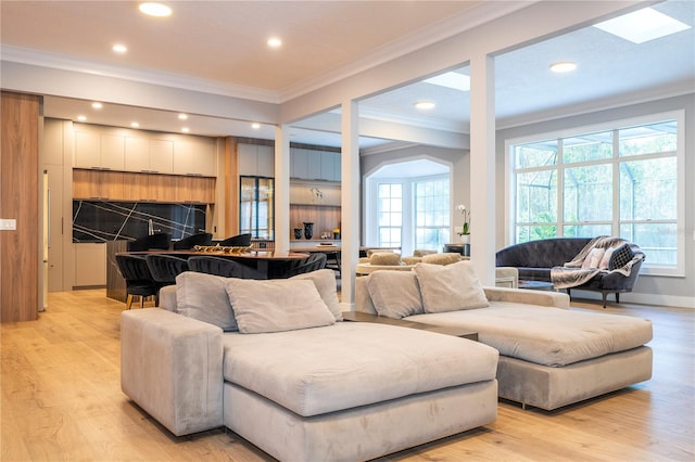 living room with crown molding and light hardwood / wood-style floors