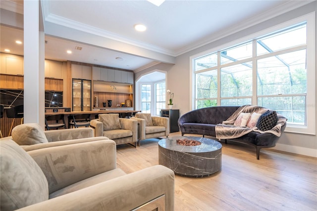 living room with light hardwood / wood-style flooring and ornamental molding