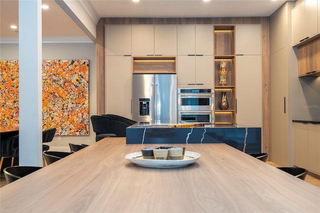 kitchen with ornamental molding and appliances with stainless steel finishes