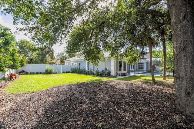 view of yard with a patio area and a fenced in pool