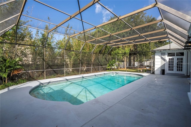 view of pool featuring a lanai, a patio area, and french doors