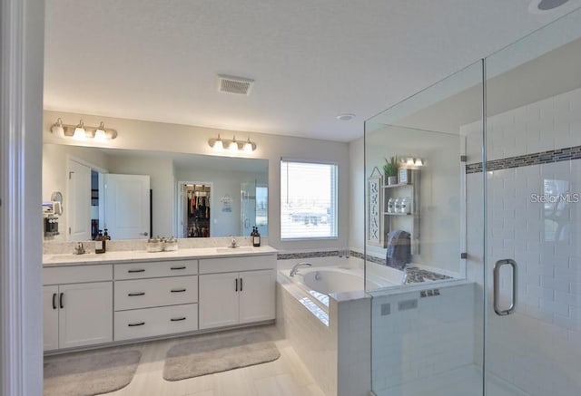 bathroom with independent shower and bath, tile patterned flooring, and vanity