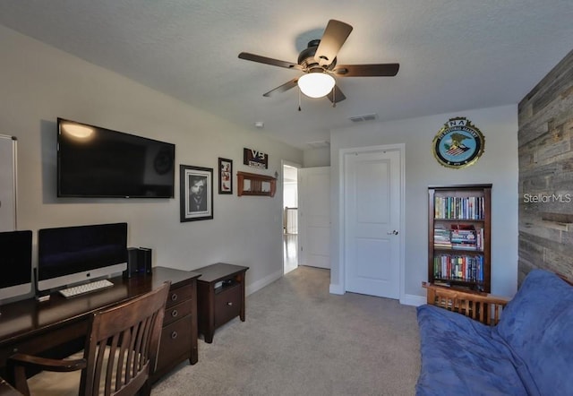 carpeted office with wood walls and ceiling fan