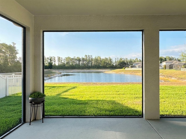 unfurnished sunroom with a water view