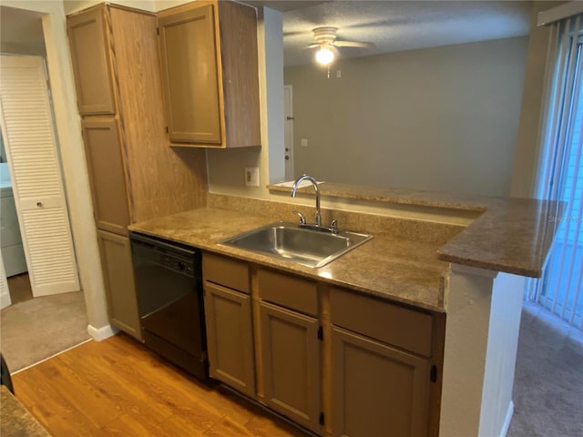 kitchen with black dishwasher, sink, kitchen peninsula, ceiling fan, and light hardwood / wood-style flooring