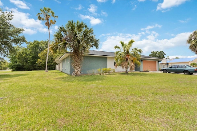 ranch-style house with a front yard and a garage