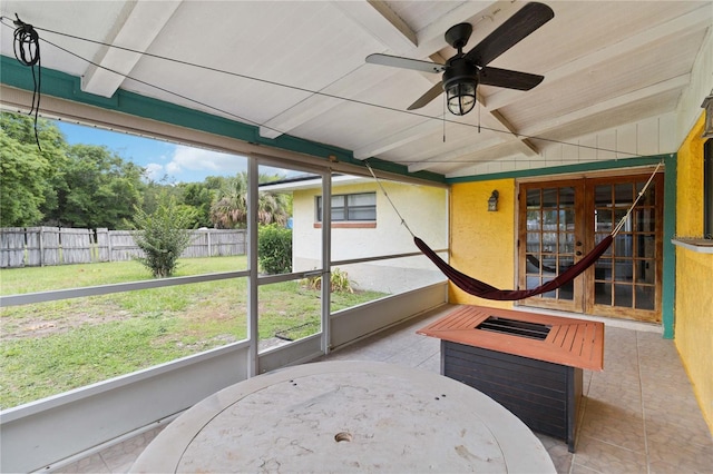 sunroom / solarium featuring lofted ceiling and ceiling fan