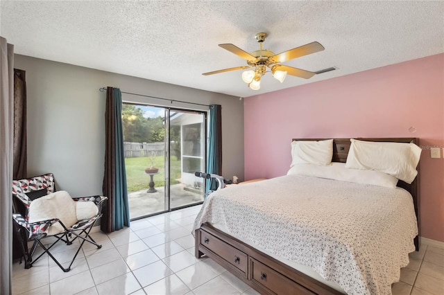 bedroom featuring light tile patterned flooring, access to outside, a textured ceiling, and ceiling fan