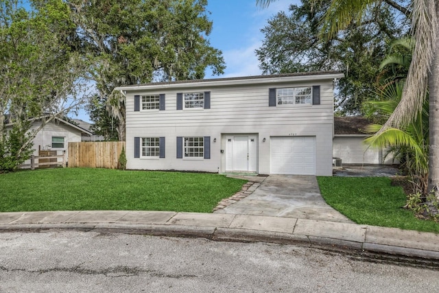 front facade with a garage and a front lawn