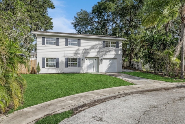 view of front of property with a front yard and a garage