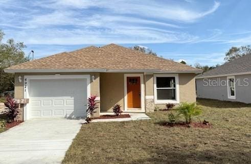 ranch-style house featuring a front yard and a garage