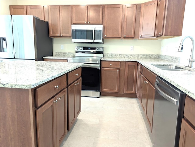 6921 Central Ave, Mulberry, FL 33860 - kitchen featuring stainless steel appliances, a sink, and light stone counters
