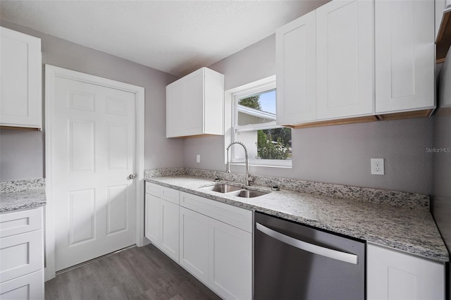 kitchen with white cabinetry, dark wood-type flooring, stainless steel dishwasher, and sink