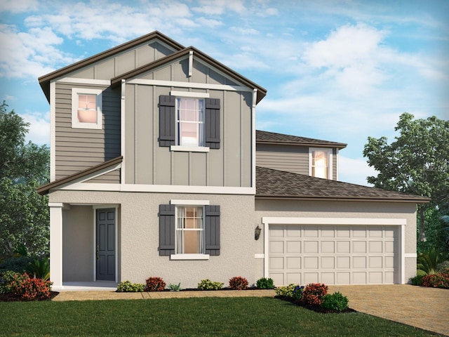 view of front of home with a garage and a front lawn