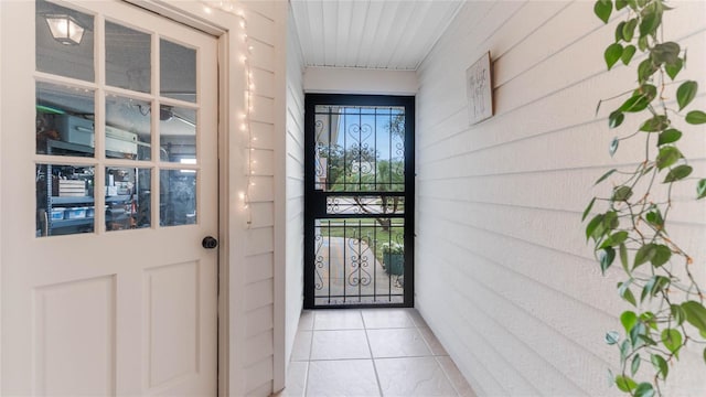 entryway with light tile patterned flooring