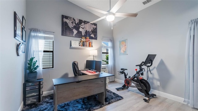 office featuring wood-type flooring, high vaulted ceiling, and ceiling fan