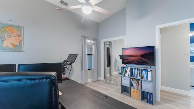 office with ceiling fan, wood-type flooring, and high vaulted ceiling