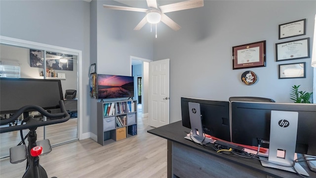 office with ceiling fan, a high ceiling, and light wood-type flooring