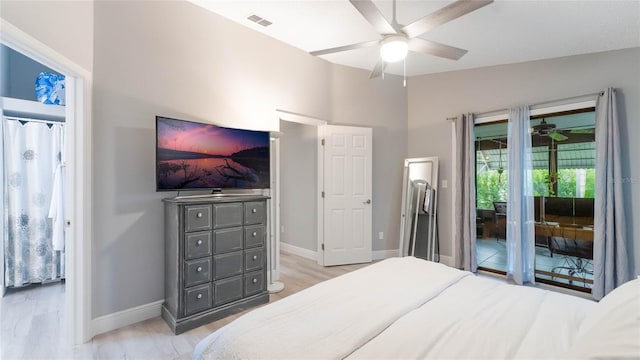 bedroom featuring access to exterior, light wood-type flooring, vaulted ceiling, and ceiling fan