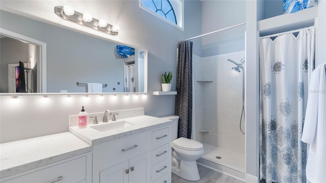 bathroom featuring wood-type flooring, vanity, toilet, and curtained shower