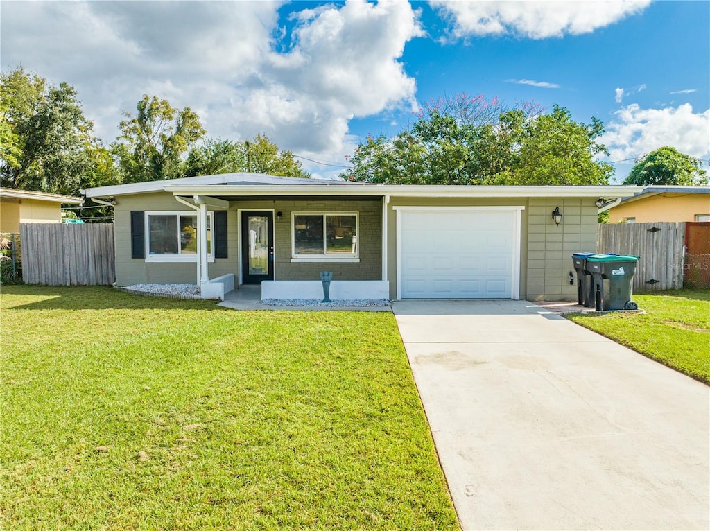 7637 Daphne Ave, Orlando, FL 32812 - ranch-style house with a garage and a front yard