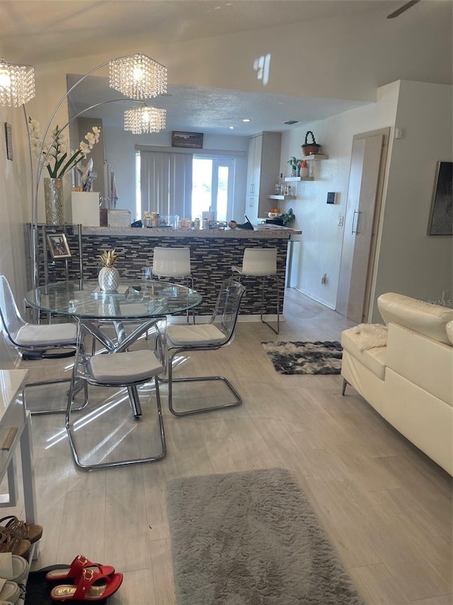 dining space featuring a textured ceiling and hardwood / wood-style flooring