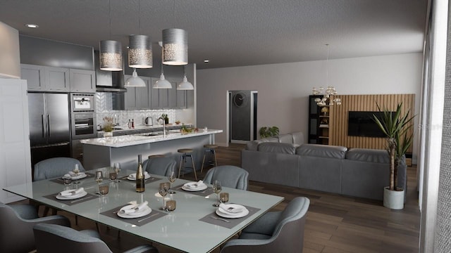 dining area featuring dark wood-type flooring and sink